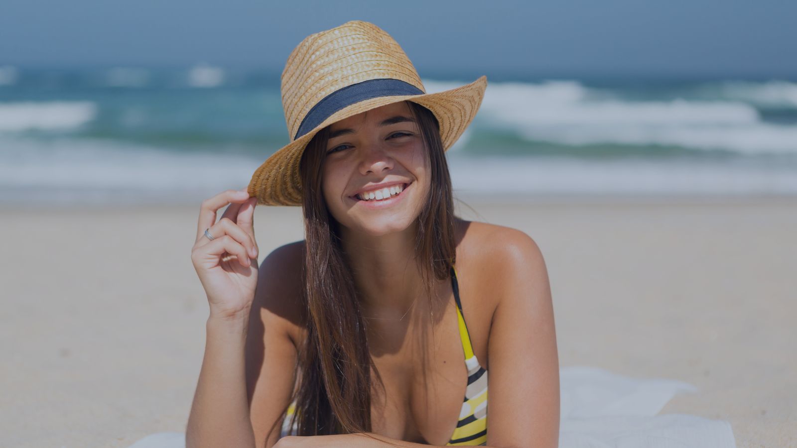 Girl at the beach wearing a hat